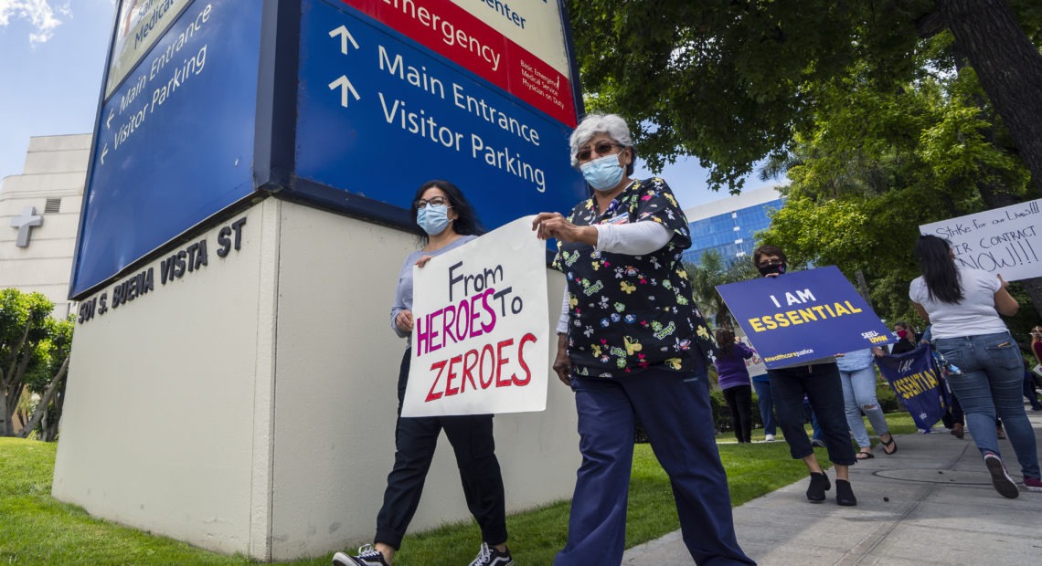 Health care workers hold a placard that says From Heroes to Zeroes during a protest against hospital under-staffing and insufficient personal protective equipment for doctors and nurses treating COVID-19 patients amid the coronavirus pandemic. The protest took place outside Saint Joseph Medical Center hospital in Burbank, Calif. on May 19.