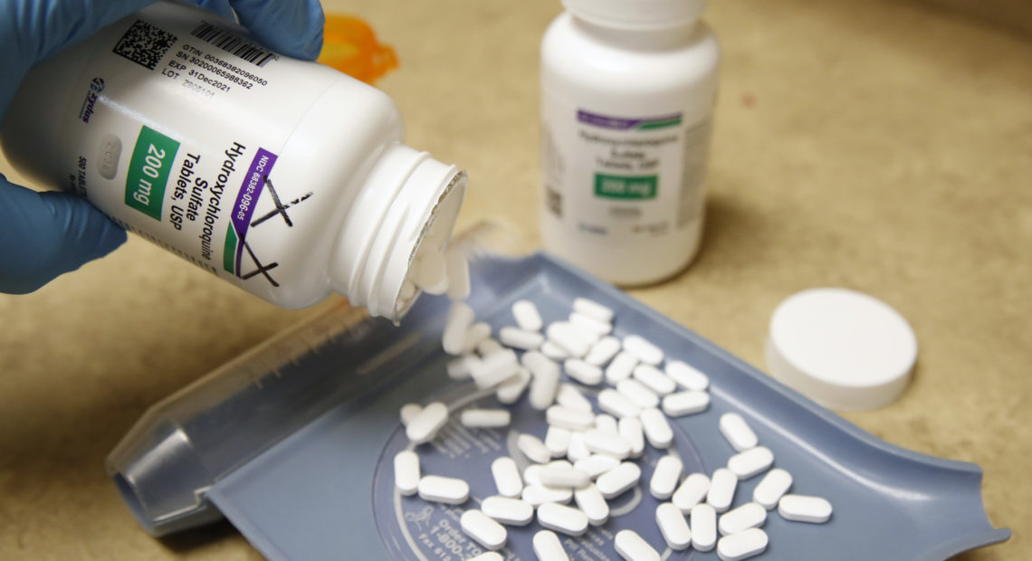 A pharmacy tech pours out pills of hydroxychloroquine May 20 at Rock Canyon Pharmacy in Provo, Utah, on May 20, 2020. After a study found COVID-19 patients using the drug were dying at higher rates, the World Health Organization announced it would suspend its clinical trial. CREDIT: George Frey/AFP via Getty Images