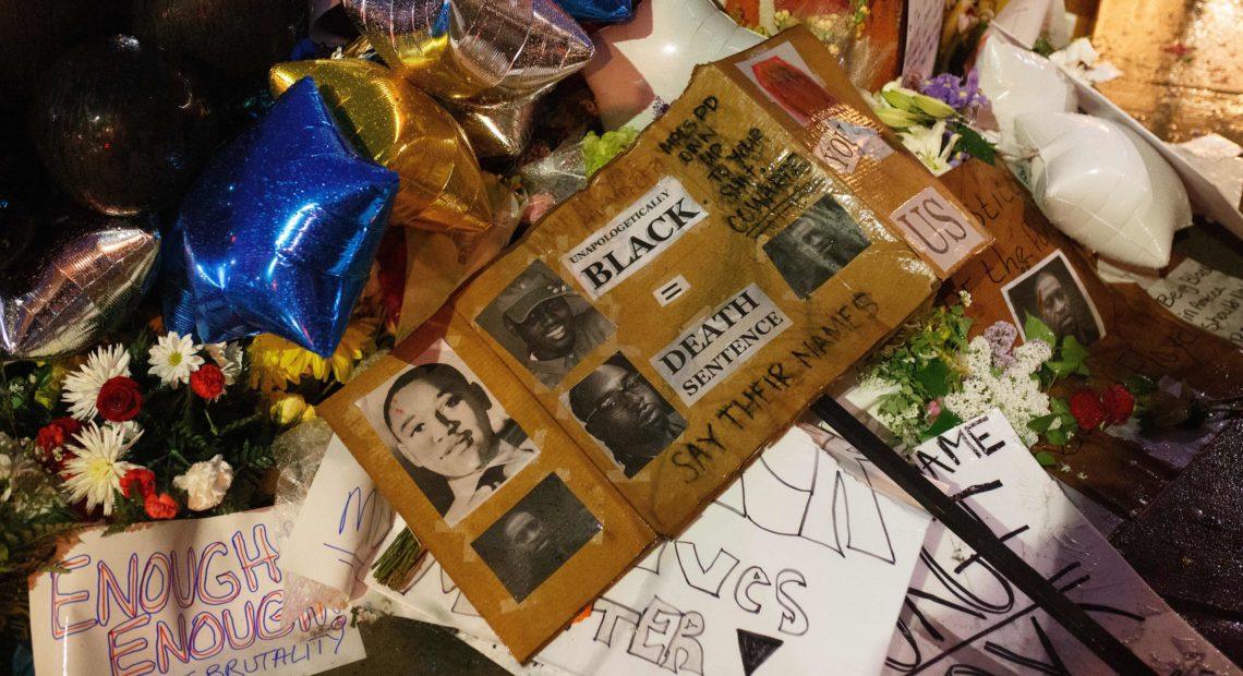 A makeshift memorial, seen Tuesday, has grown near where George Floyd died while in the custody of Minneapolis police. Mourners have brought flowers, signs and balloons to the site in Floyd's memory