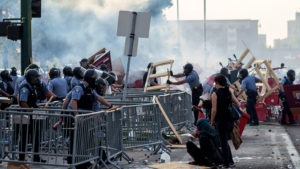 Protesters approach riot police during a demonstration Wednesday evening in Minneapolis. The protests turned violent — even deadly — as unrest erupted once more over the death of Floyd.