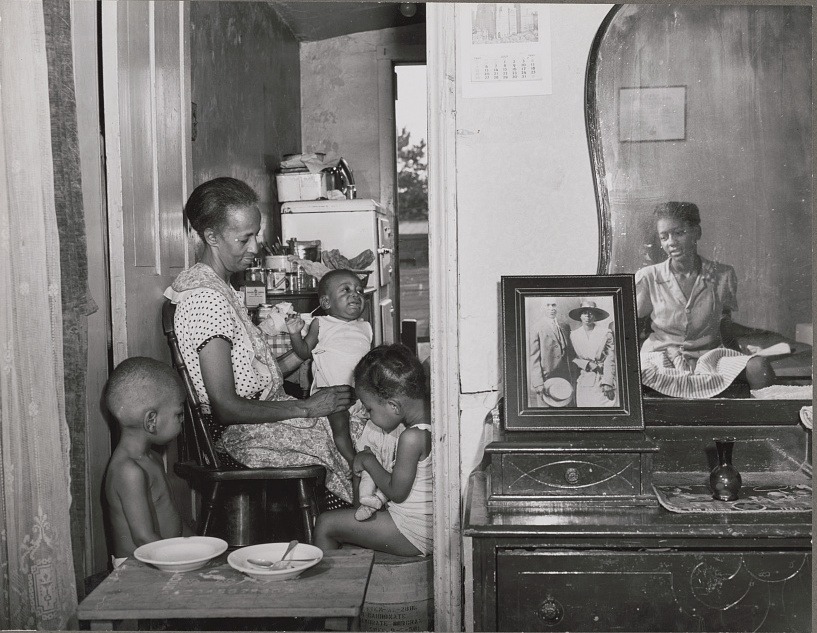 While working for the Farm Security Administration, Gordon Parks took this 1942 photo of Ella Watson at her home in Washington, D.C., with her three grandchildren and daughter. Gordon Parks/Library of Congress Prints and Photographs Division