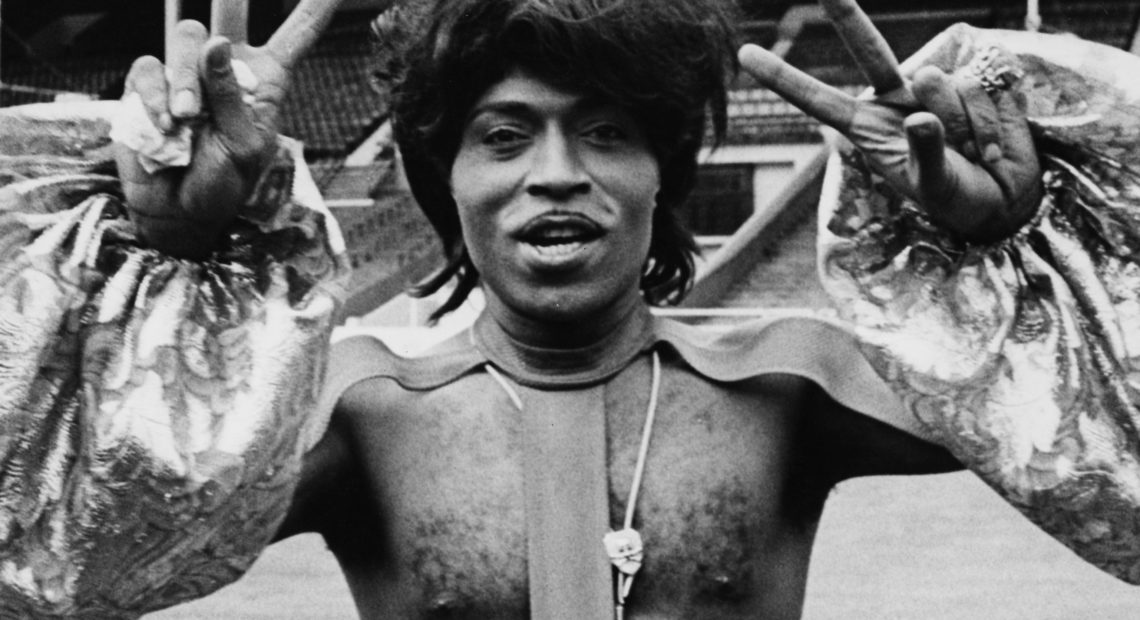 Singer Little Richard making peace sign and wearing an outlandish outfit as he prepares to perform at Wembley Stadium, 1972. (Photo by Rosemary Matthews/Keystone Features/Getty Images) Rosemary Matthews/Getty Images