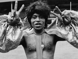 Singer Little Richard making peace sign and wearing an outlandish outfit as he prepares to perform at Wembley Stadium, 1972. (Photo by Rosemary Matthews/Keystone Features/Getty Images) Rosemary Matthews/Getty Images