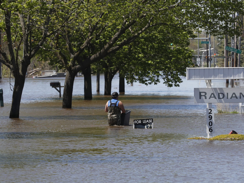 Waters overflow the Tittabawassee River on Wednesday in Midland, Mich. CREDIT: Carlos Osorio/AP