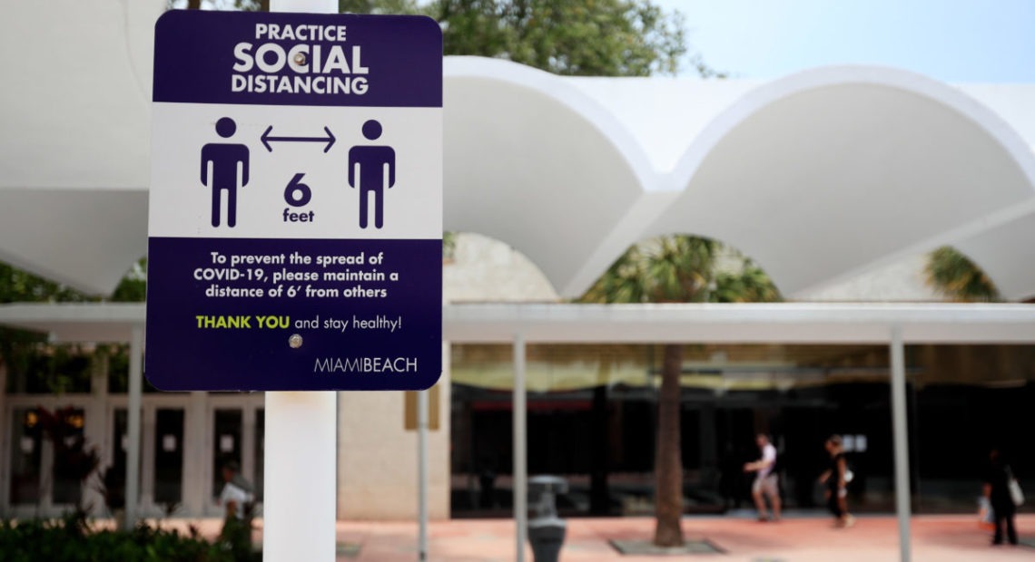 Signage reminds people to social distance on Lincoln Mall, May 20, 2020 in Miami Beach, Florida. The city of Miami Beach is allowing non-essential "retail stores, personal grooming establishments, offices and museums" to reopen staring today.