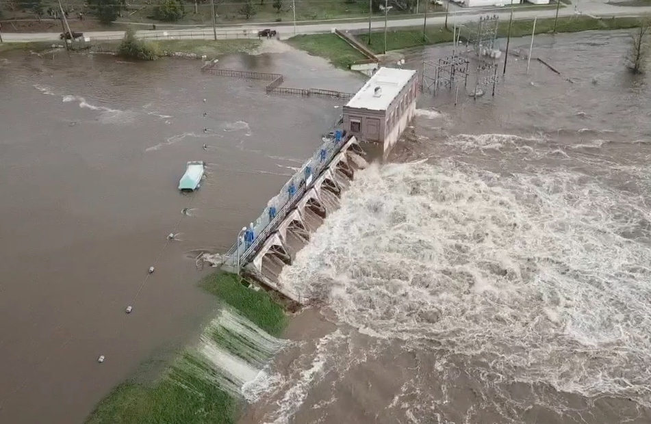 Water overruns the Sanford Dam in Michigan on Tuesday. The National Weather Service called the flooding "extremely dangerous" and said it was caused by "catastrophic failures" at two dams. CREDIT: TC Vortex via Reuters