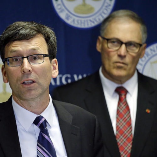 Washington Attorney General Bob Ferguson, left, speaks as Gov. Jay Inslee looks on during a news conference, Thursday, Dec. 8, 2016, in Seattle, where Ferguson announced a lawsuit against agrochemical giant Monsanto over pollution from PCBs.
