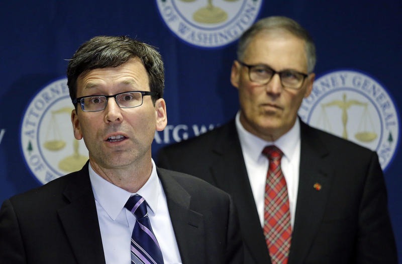 Washington Attorney General Bob Ferguson, left, speaks as Gov. Jay Inslee looks on during a news conference, Thursday, Dec. 8, 2016, in Seattle, where Ferguson announced a lawsuit against agrochemical giant Monsanto over pollution from PCBs.