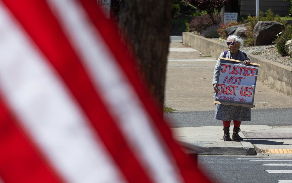 Fran Cuhtahlatah stands in protest at the corner of North Main Street and West Fifth Avenue in Ellensburg, Kittitas County, June 14, 2020. While other local residents have protested recently, Cuhtahlatah has been out quietly protesting in the community for the past three years. CREDIT: Matt M. McKnight/Crosscut