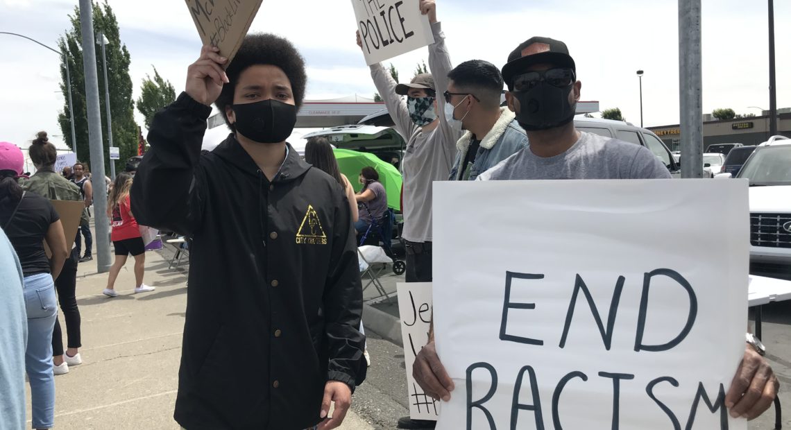 Rapper Karma (left), who started making music in Richland and now lives in Seattle, said people weren’t doing enough before now. He said the protesters were “warming his heart to see how much love is in this city.” CREDIT: Courtney Flatt/NWPB