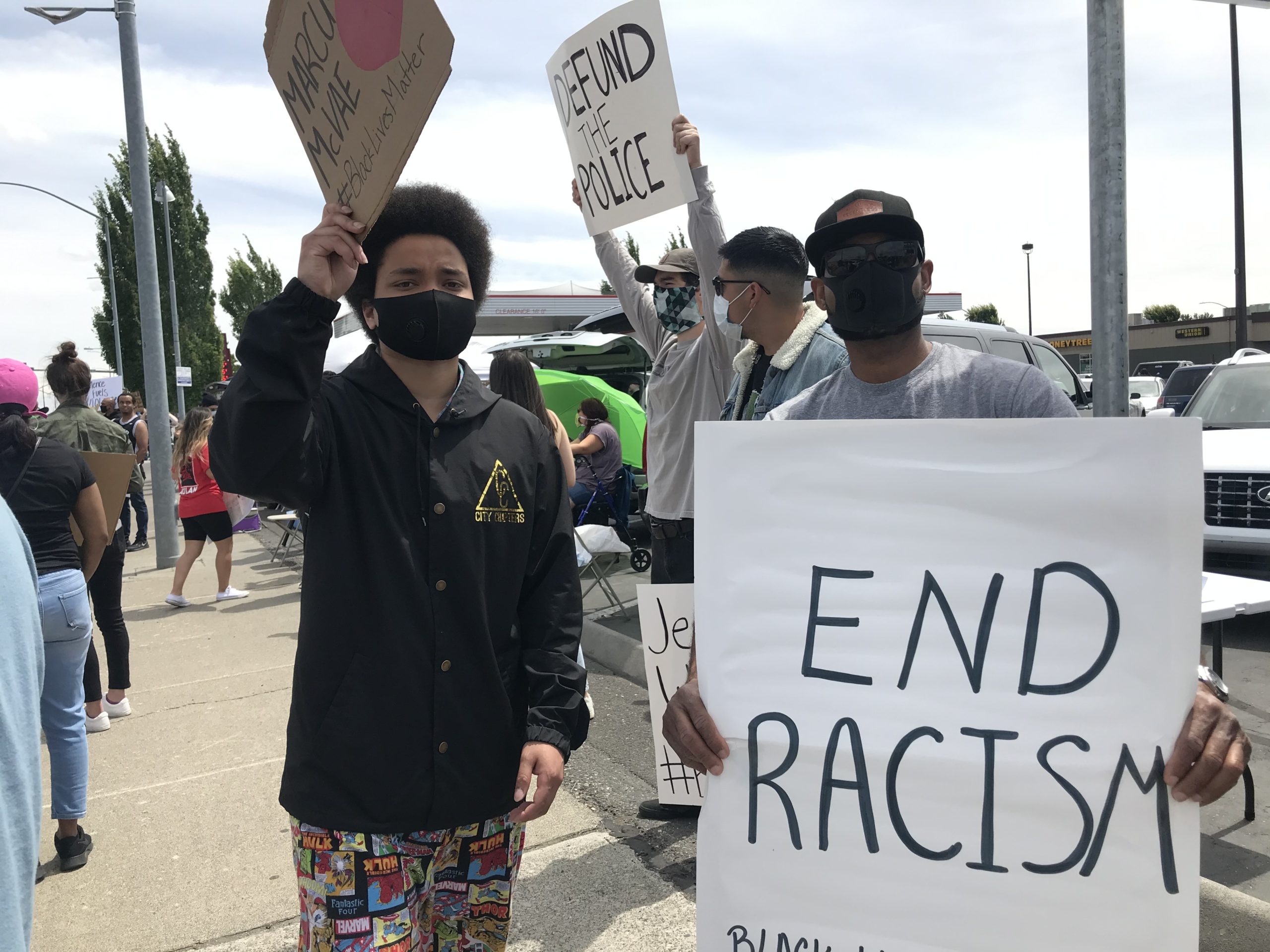 Rapper Karma (left), who started making music in Richland and now lives in Seattle, said people weren’t doing enough before now. He said the protesters were “warming his heart to see how much love is in this city.” CREDIT: Courtney Flatt/NWPB