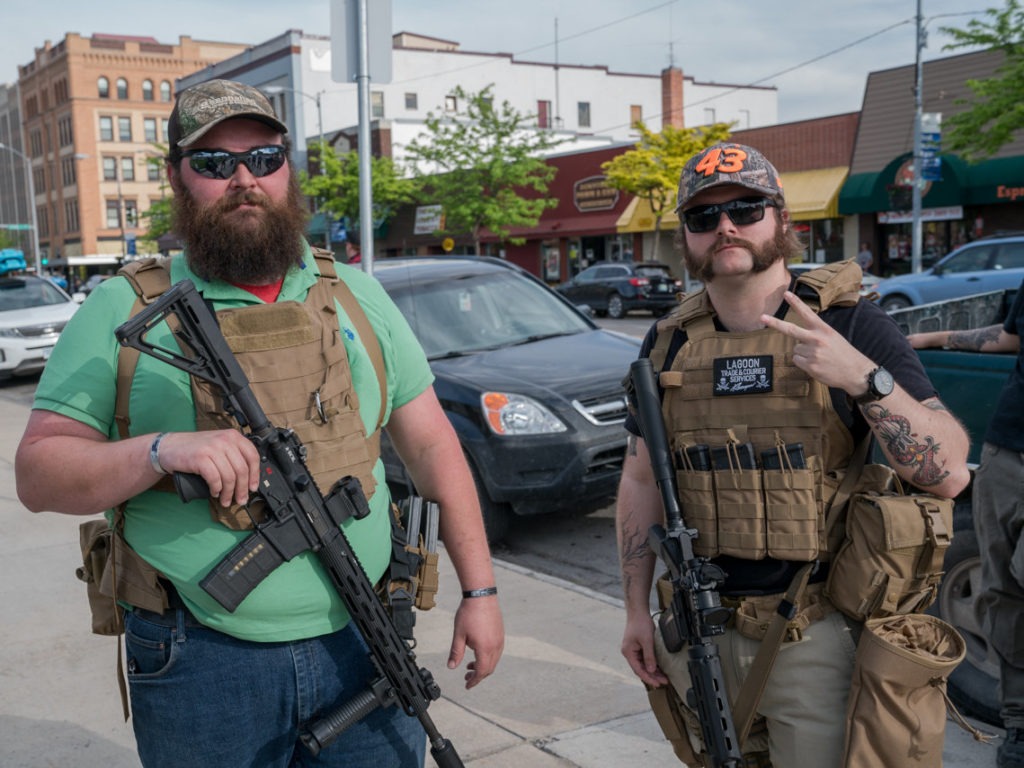 Max Metcalf (left) and Justin, who wouldn't give his last name due to safety and employment concerns, say they are at a rally in Missoula, Mont., to protect protesters from violent agitators. CREDIT: Nick Mott/Montana Public Radio
