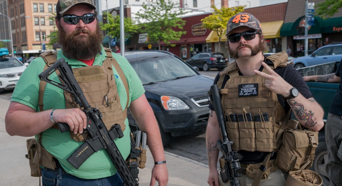 Max Metcalf (left) and Justin, who wouldn't give his last name due to safety and employment concerns, say they are at a rally in Missoula, Mont., to protect protesters from violent agitators. CREDIT: Nick Mott/Montana Public Radio