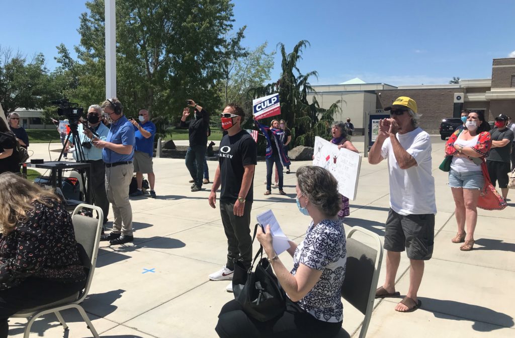 Protesters at an outside news media briefing heckled Gov. Jay Inslee at Columbia Basin College June 30, 2020. “Say anything you want – this is a free country,” Inslee later said once it was moved inside. “Disparage any governor or senator or president that you desire. But do it with a mask on.”