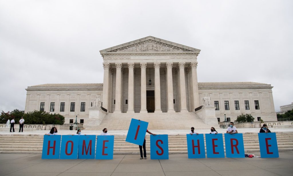 Activists hold a banner in front of the Supreme Court in Washington, D.C., on Thursday as the court rejected the Trump administration's move to rescind the Deferred Action for Childhood Arrivals program. Nicholas Kamm/AFP via Getty Images