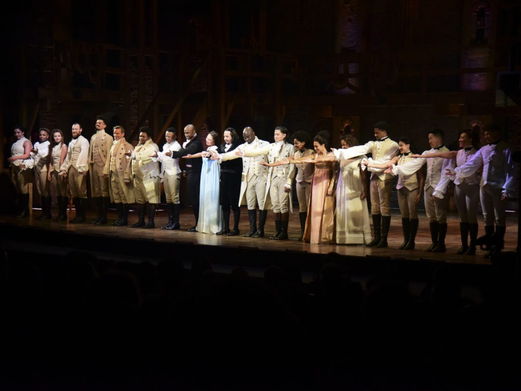 The cast of Hamilton, including its composer and creator, Lin-Manuel Miranda, center, receive a standing ovation in San Juan, Puerto Rico on Jan. 11, 2019. The musical is set to stream on Disney+ this week. CREDIT: Carlos Giusti/AP