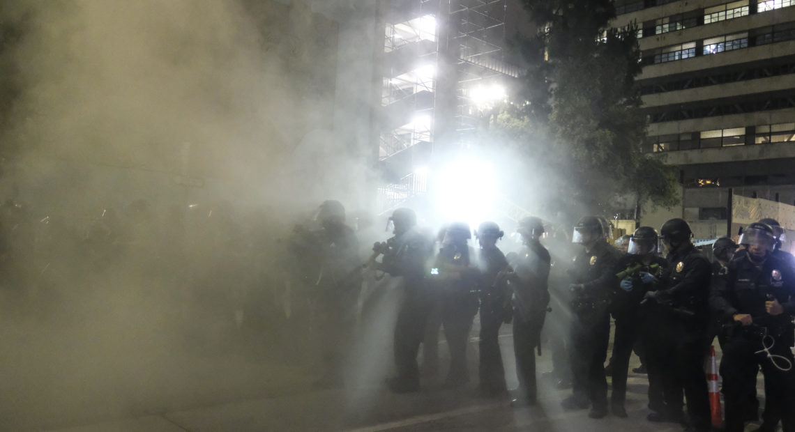 Police officers fire rubber bullets May 29 during a Los Angeles protest over the death of George Floyd. CREDIT: Ringo H.W. Chiu/AP