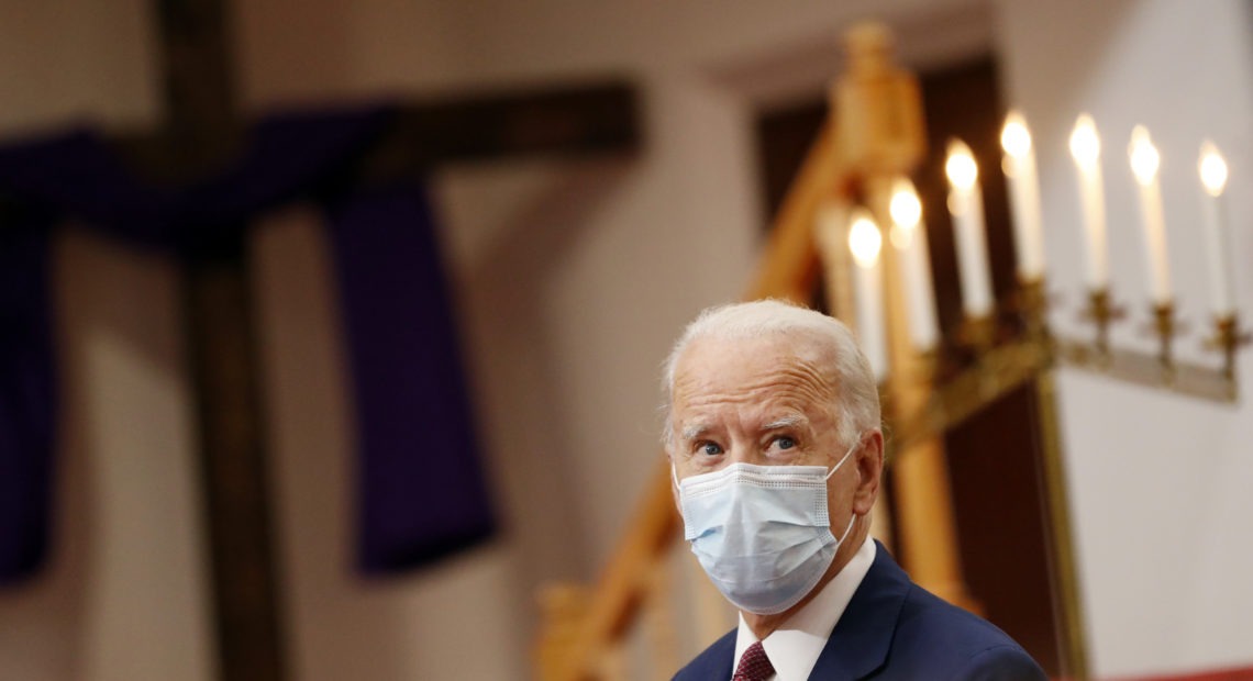 Former Vice President Joe Biden listens Monday as clergy members and community activists speak during a visit to Bethel AME Church in Wilmington, Del.