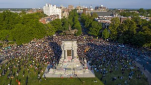 A large group of protesters gathered around the statue of Confederate Gen. Robert E. Lee, on Tuesday in Richmond, Va. The crowd protesting police brutality chanted, "Tear it down."