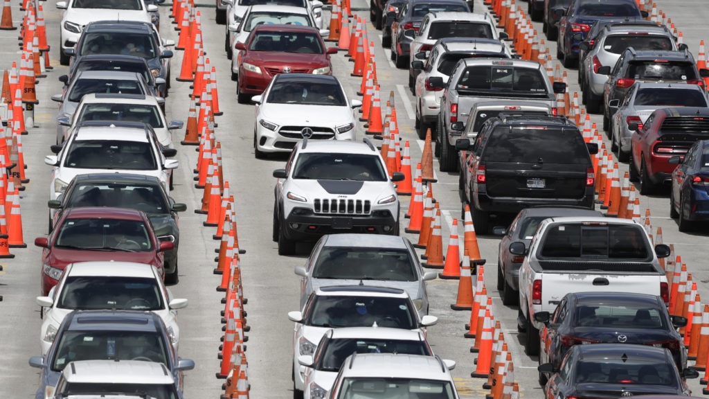 Cars line up for coronavirus testing outside Hard Rock Stadium in Miami Gardens, Fla. Florida is one of many states reporting spikes in COVID-19 cases in recent days, as the number of confirmed cases worldwide has topped 10 million. Wilfredo Lee/AP