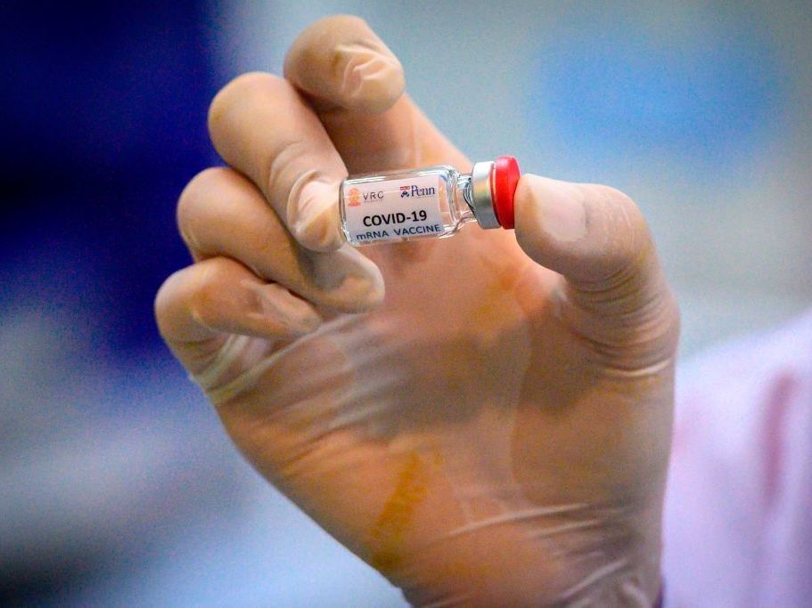 A laboratory technician holds a dose of a COVID-19 vaccine candidate ready for a trial in May 2020. CREDIT: Mladen Antonov/AFP via Getty Images