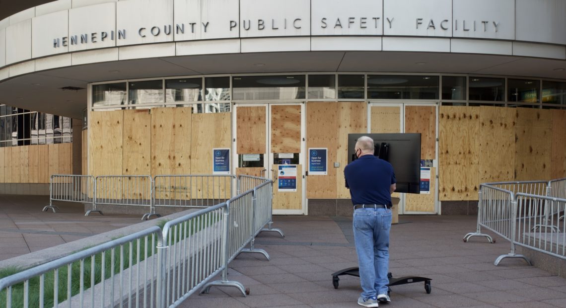 A facility worker brings a TV inside the Hennepin County Public Safety Facility on Monday in Minneapolis, part of preparations for the first court hearing for former police Officer Derek Chauvin. Kerem Yucel /AFP via Getty Images