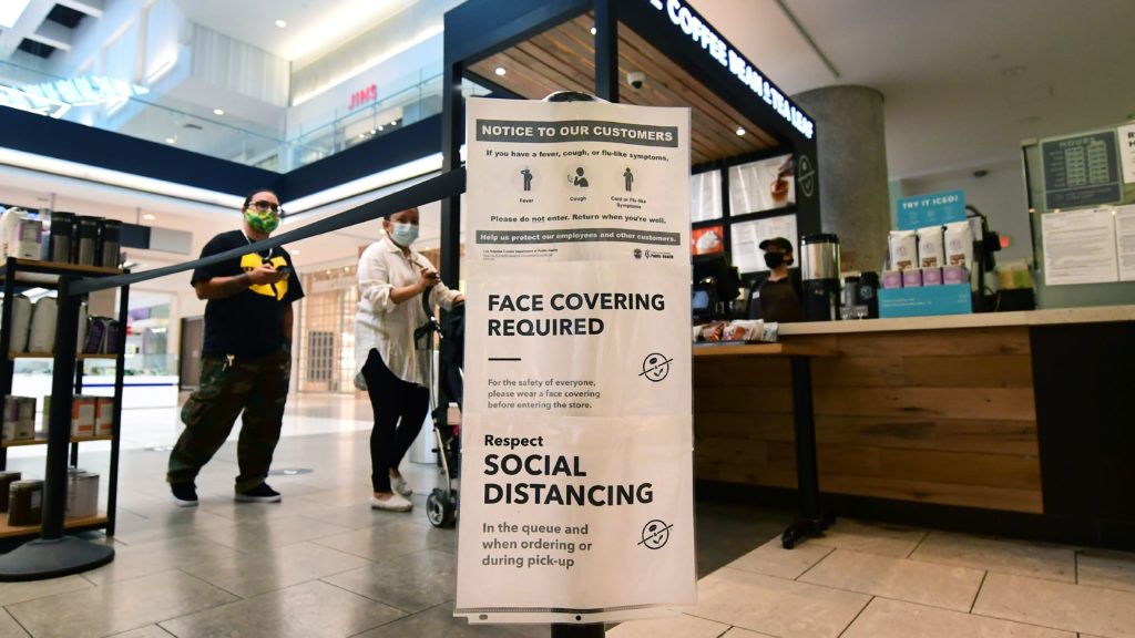 Social distancing instructions are posted at California's Westfield Santa Anita shopping mall on June 12, as local businesses enter Phase 3 reopening. Frederic J. Brown/AFP/Getty Images
