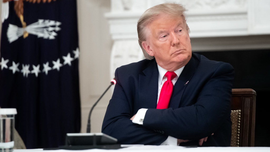 President Trump, seen here during a meeting Thursday at the White House, shared a video on Twitter with a fake CNN headline. The social media network flagged the doctored footage as "manipulated media." CREDIT: Saul Loeb/AFP via Getty Images