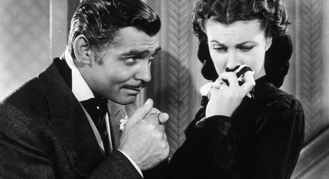 American actor Clark Gable in his role as Rhett Butler kissing the hand of a tearful Scarlett O'Hara, played by Vivien Leigh in 'Gone With The Wind'.