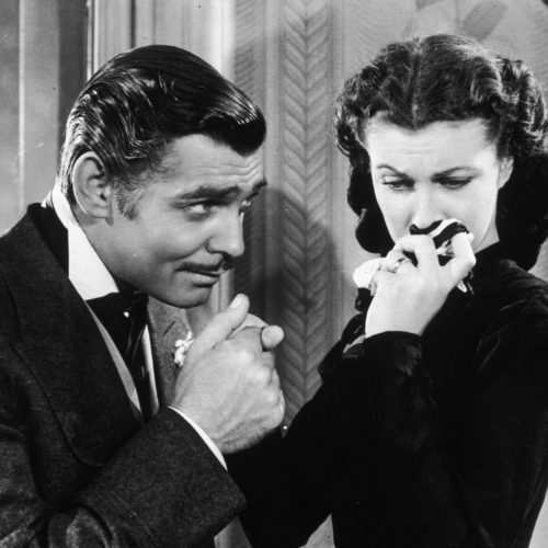 American actor Clark Gable in his role as Rhett Butler kissing the hand of a tearful Scarlett O'Hara, played by Vivien Leigh in 'Gone With The Wind'.
