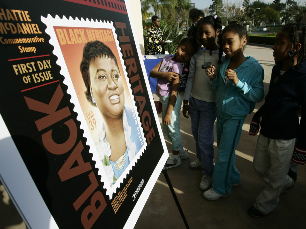 Los Angeles school children attend a ceremony unveiling a commemorative U.S. Postal Service stamp for actor Hattie McDaniel in 2006, in Beverly Hills, Calif. McDaniel, also a singer, radio and television personality, was the first African American to win an Oscar, for her portrayal of Mammy in Gone With the Wind. CREDIT: Damian Dovarganes/AP