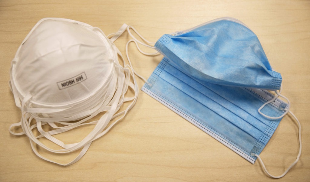 N95 particulate respirator masks (left) block at least 95% of small airborne particulates in the air. However, they are still in short supply and should be reserved for medical workers. Surgical face masks (right) are most effective at protecting others from the wearer's droplets. CREDIT: Victor J. Blue/Bloomberg via Getty Images