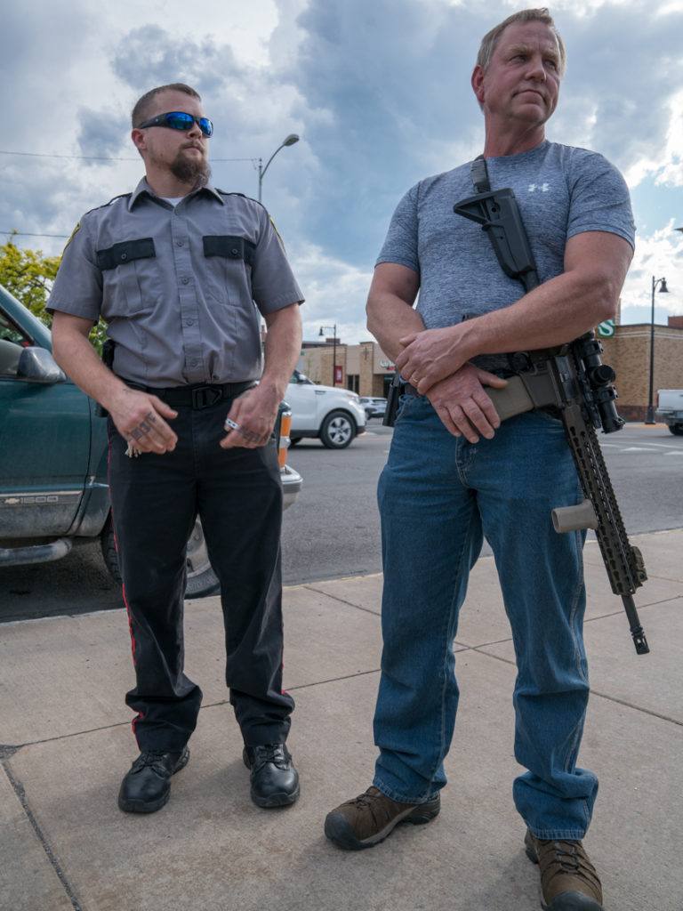 Calvin (right), who wouldn't give his last name, citing safety, says he's concerned about rumors of antifa activists coming to Missoula. But such rumors have been debunked. CREDIT: Nick Mott/Montana Public Radio