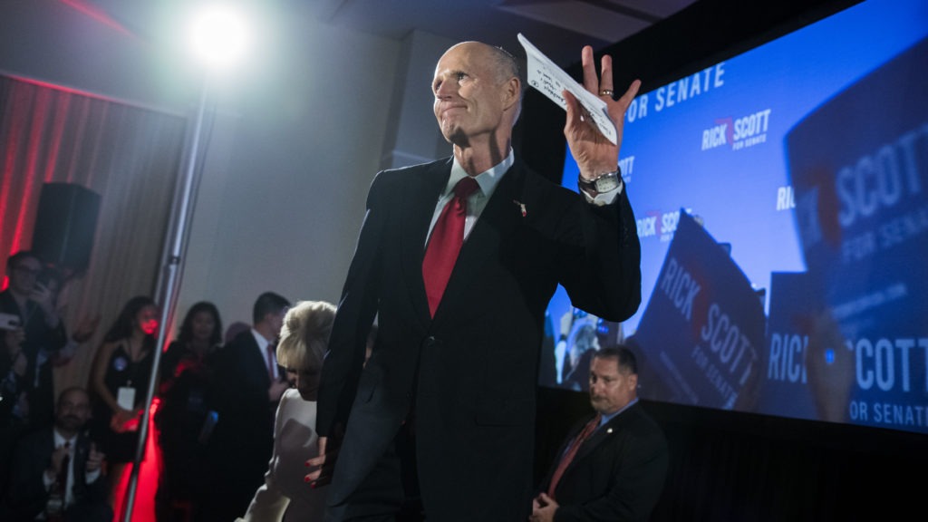 Republican Rick Scott, now a U.S. senator from Florida, takes the stage at his election night party in 2018. Days later, as his margin of victory tightened due to mail votes still being processed, he accused Democrats of trying to "steal" the election without providing evidence. CREDIT: Tom Williams/CQ Roll Call via Getty Images