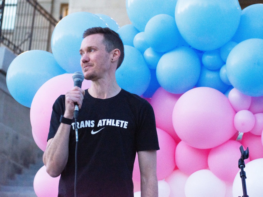 Chris Mosier, the first known transgender person to qualify for an Olympic trial, joined protesters in Boise, Idaho, to push back against legislation targeting transgender residents. CREDIT: James Dawson/Boise State Public Radio