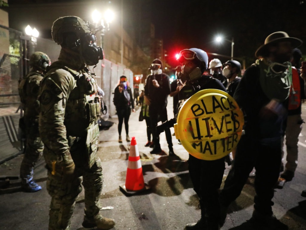 Federal law enforcement agents confront protesters in Portland, Ore., on Sunday, July 26, 2020. Spencer Platt/Getty Images