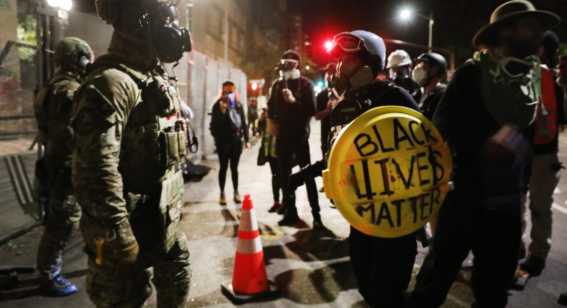 Federal law enforcement agents confront protesters in Portland, Ore., on Sunday, July 26, 2020. Spencer Platt/Getty Images