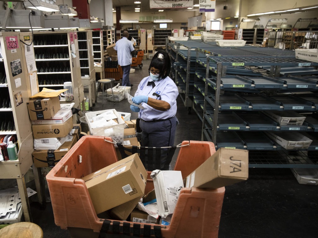 Letter carrier Henrietta Dixon, a 30-year veteran, sorts mail to be delivered before she sets out on her route in Philadelphia. Changes within the Postal Service could make some deliveries late. CREDIT: Matt Rourke/AP