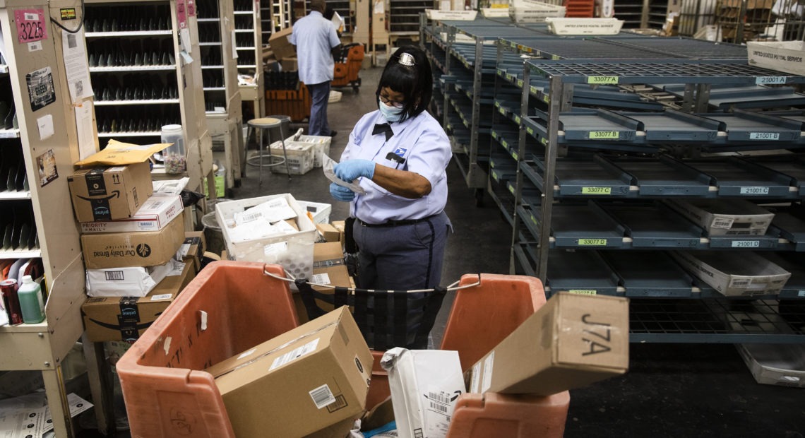 Letter carrier Henrietta Dixon, a 30-year veteran, sorts mail to be delivered before she sets out on her route in Philadelphia. Changes within the Postal Service could make some deliveries late. CREDIT: Matt Rourke/AP