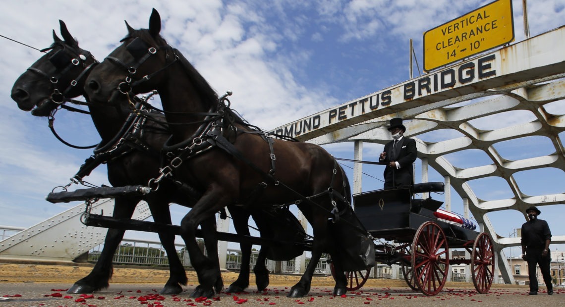 The casket of Rep. John Lewis crosses the Edmund Pettus Bridge by horse-drawn carriage during a memorial service for Lewis on July 26 in Selma, Ala. CREDIT: John Bazemore/AP