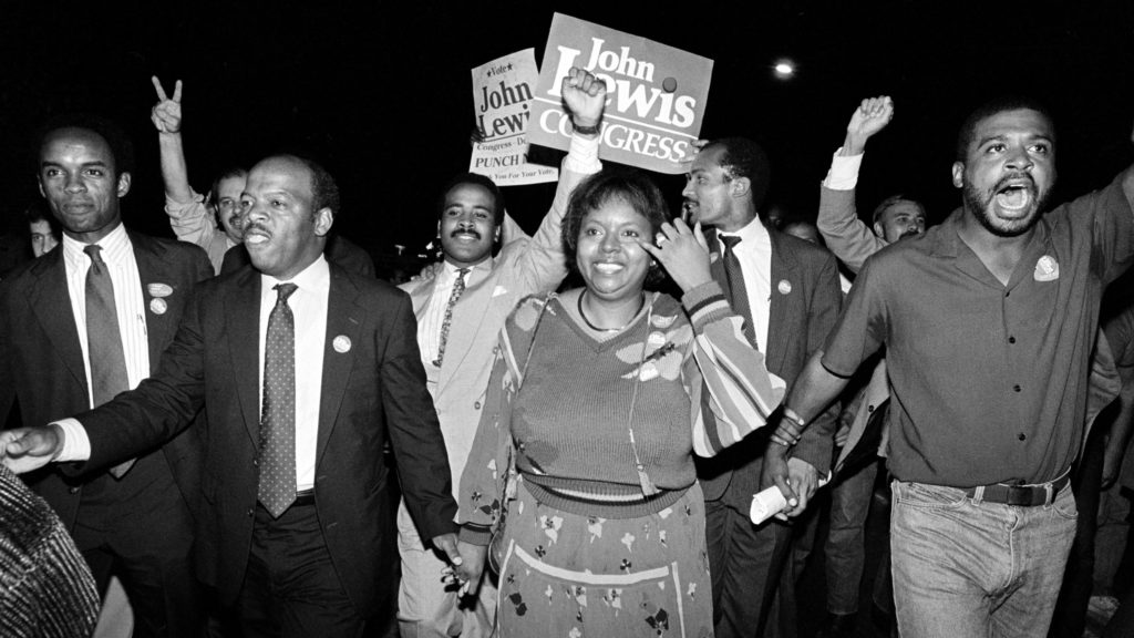John Lewis and his wife, Lillian, lead supporters from his campaign headquarters to an Atlanta hotel for a victory party in 1986. CREDIT: Linda Schaeffer/AP