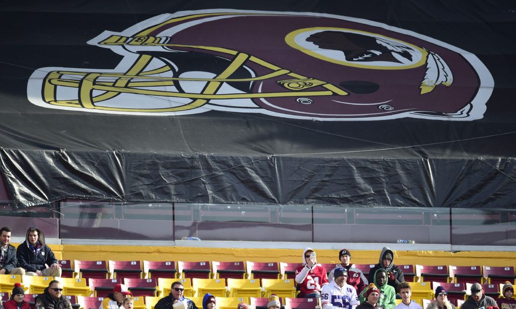 Fans sit in the stands before the start of a game between the New York Giants and Washington Redskins at FedEx Field in 2019 in Landover, Md. The Redskins, and other teams, are reviewing their names. CREDIT: Patrick McDermott/Getty Images