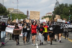 Black Students Matter demonstrators march en route to a rally at the Department of Education in Washington, D.C., on June 19. CREDIT: Tom Williams/CQ-Roll Call via Getty Images