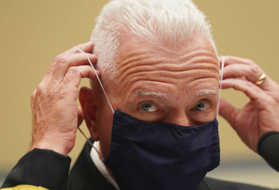 Adm. Brett Giroir, assistant secretary for health in the Department of Health and Human Services, adjusts his face mask while testifying this month before a House subcommittee on the coronavirus crisis. CREDIT: Kevin Lamarque/Pool/Getty Images