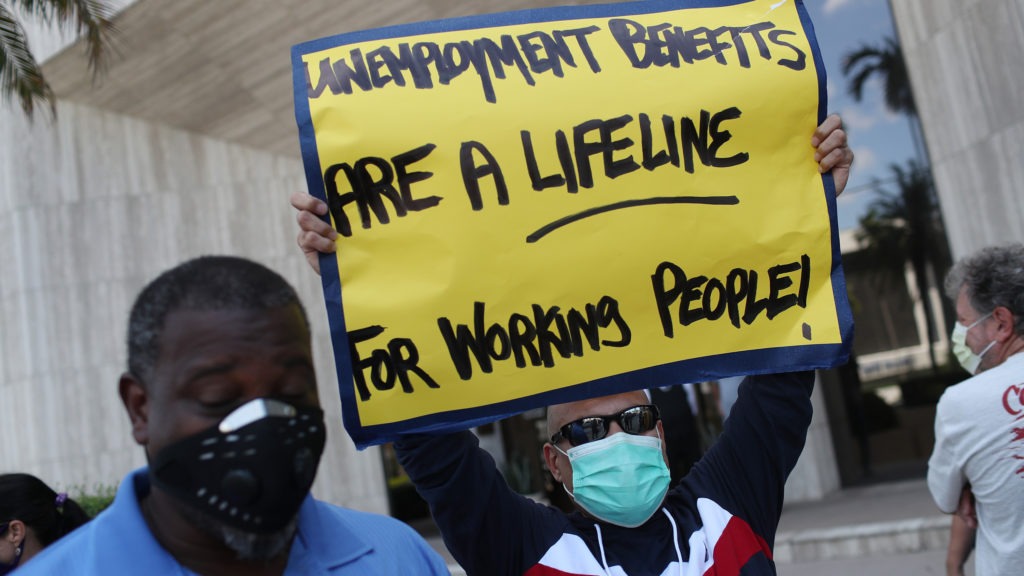 Demonstrators in Florida ask senators to support the continuation of boosted unemployment benefits. Joe Raedle/Getty Images