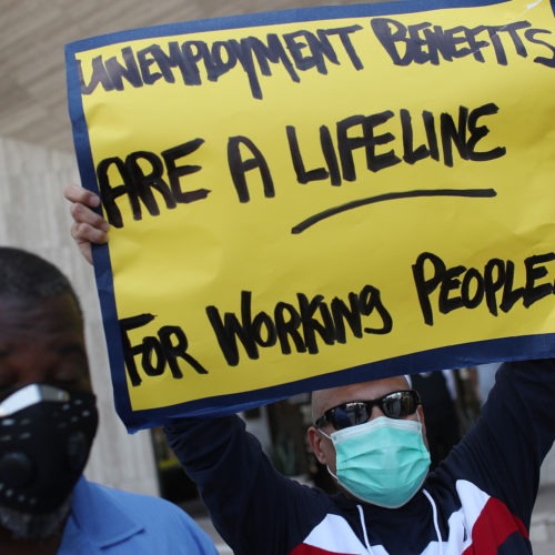 Demonstrators in Florida ask senators to support the continuation of boosted unemployment benefits. Joe Raedle/Getty Images