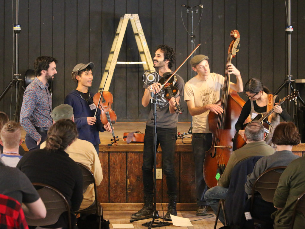 Jake Blount leads a musical performance in his workshop during the Youth Traditional Song Weekend. CREDIT: Lorelei Erisis