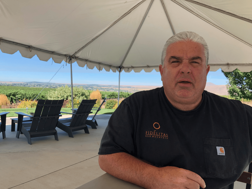 Charlie Hoppes sits under his outdoor tasting tent. He's brought in new furniture so patrons can taste wines outdoors while maintaining social distance. He says some of the wineries he works for have decided not to make a 2020 vintage.