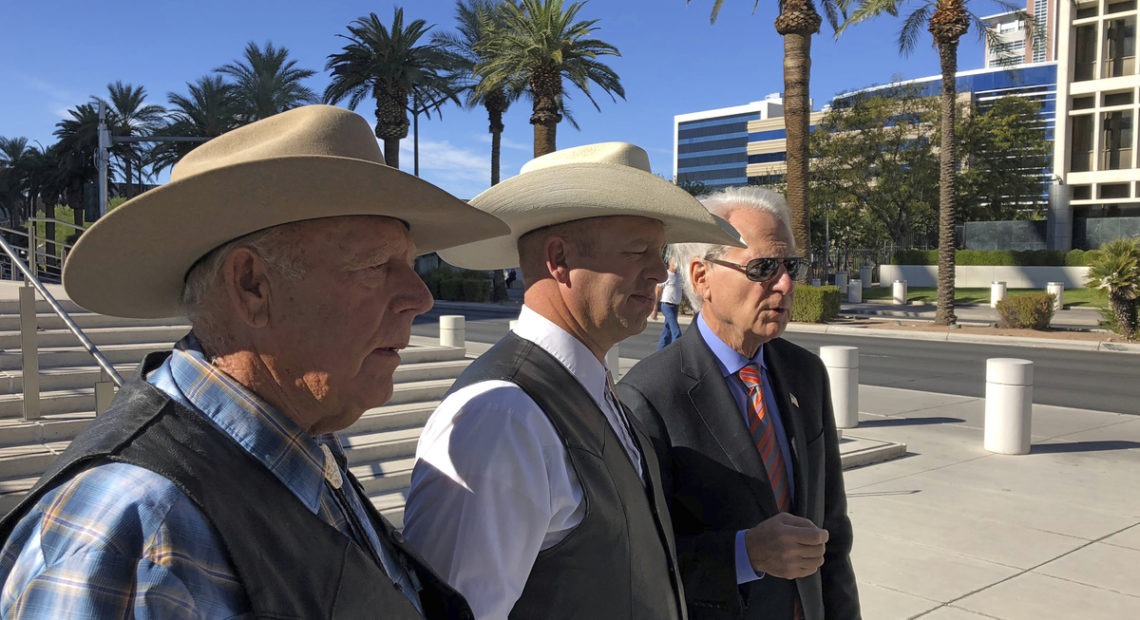 A federal appeals court has confirmed the dismissal of a criminal case against Nevada rancher Cliven Bundy (left), seen in 2018 with his son Ryan Bundy and attorney Larry Klayman. CREDIT: Ken Ritter/AP