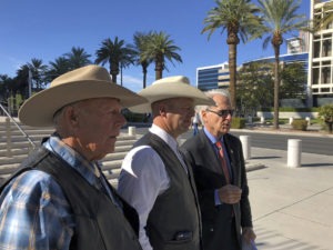 A federal appeals court has confirmed the dismissal of a criminal case against Nevada rancher Cliven Bundy (left), seen in 2018 with his son Ryan Bundy and attorney Larry Klayman. CREDIT: Ken Ritter/AP